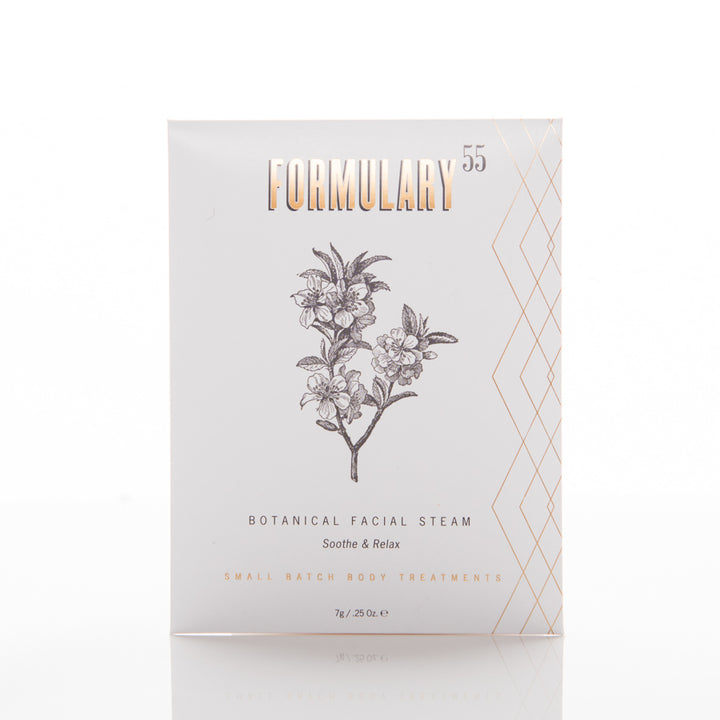 A white packaging of "Formulary 55" Botanical Facial Steam. The front features a monochrome illustration of a flowering plant and the text "Soothe & Relax." Additional text at the bottom reads "Small Batch Body Treatments." The package contains 7oz / 25g of product.